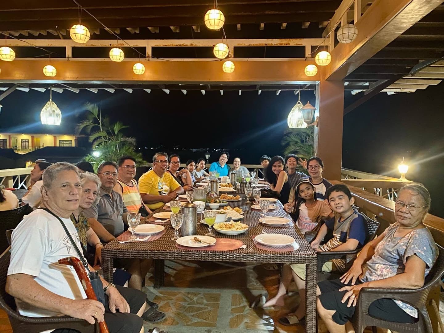 A multi-generational family gathered for dinner on the bayside terrace at Cherish Resort, Masbate City