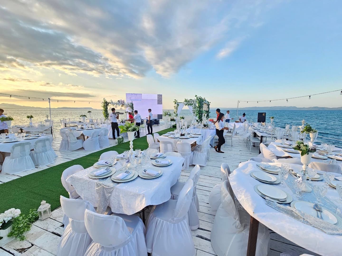The bayside event deck set for a celebration at golden hour at Cherish Resort, Masbate City