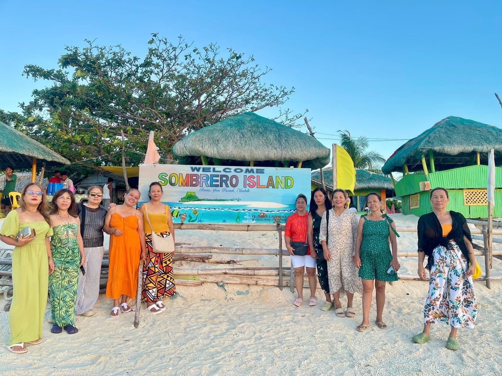 Guests on the white-sand beach at Sombrero Island in the Burias group off Masbate